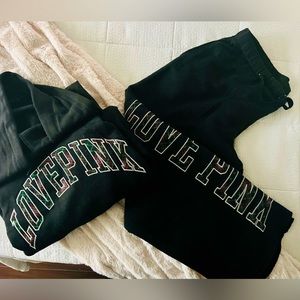 PINK women’s black fleece hooded sweatshirt and fleece sweat pants.